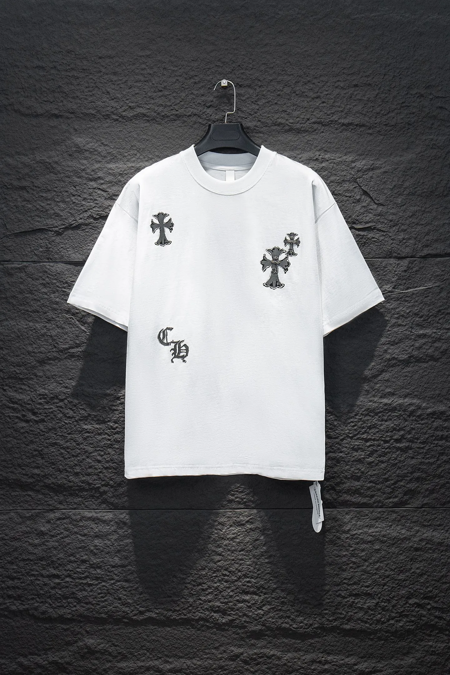 🅿️188 Style No.: 7249# Chrome hearts• 25ss ⚠YB custom-woven and custom-dyed fabrics, colors, prints, styles, accessories, hardware. The fabric is woven by imported machines. The uniqueness of the cloth texture creates a perfect garment effect. The fabric is made of 260-gram net cloth with 320-gram 1*1 ribs. 4-color environmentally friendly custom-dyed fabrics, threads in the same cylinder, no color difference.  Gradient graffiti on garments, hand-made graffiti technology on garments, the details of the collar, pockets, cuffs, and front and rear threads are clearly visible. The printing uses Japanese BROTHER white ink digital direct-injection garment printing. This model is a global limited edition. In order to present a product like a work of art, after a long period of repeated determination of details, a very high-standard garment is presented. The front chest is made of direct-injection printing environmentally friendly glue material, using a mechanized printing process. Mechanical printing has high precision, the positioning accuracy can reach ±0.02mm, and the quality is stable.   The body of the garment is processed with hand-nailed hardware elements, which greatly increases the interest of the garment and creates a unique visual effect. The special washing effect creates a unique aged effect.  Croix Heart Short Sleeve must be the first short-sleeved piece in spring and summer that blurs the boundaries of unisex style. It has a classic dropped shoulder oversize version and a loose and casual upper body.  Color: Black White Size: S M L XL